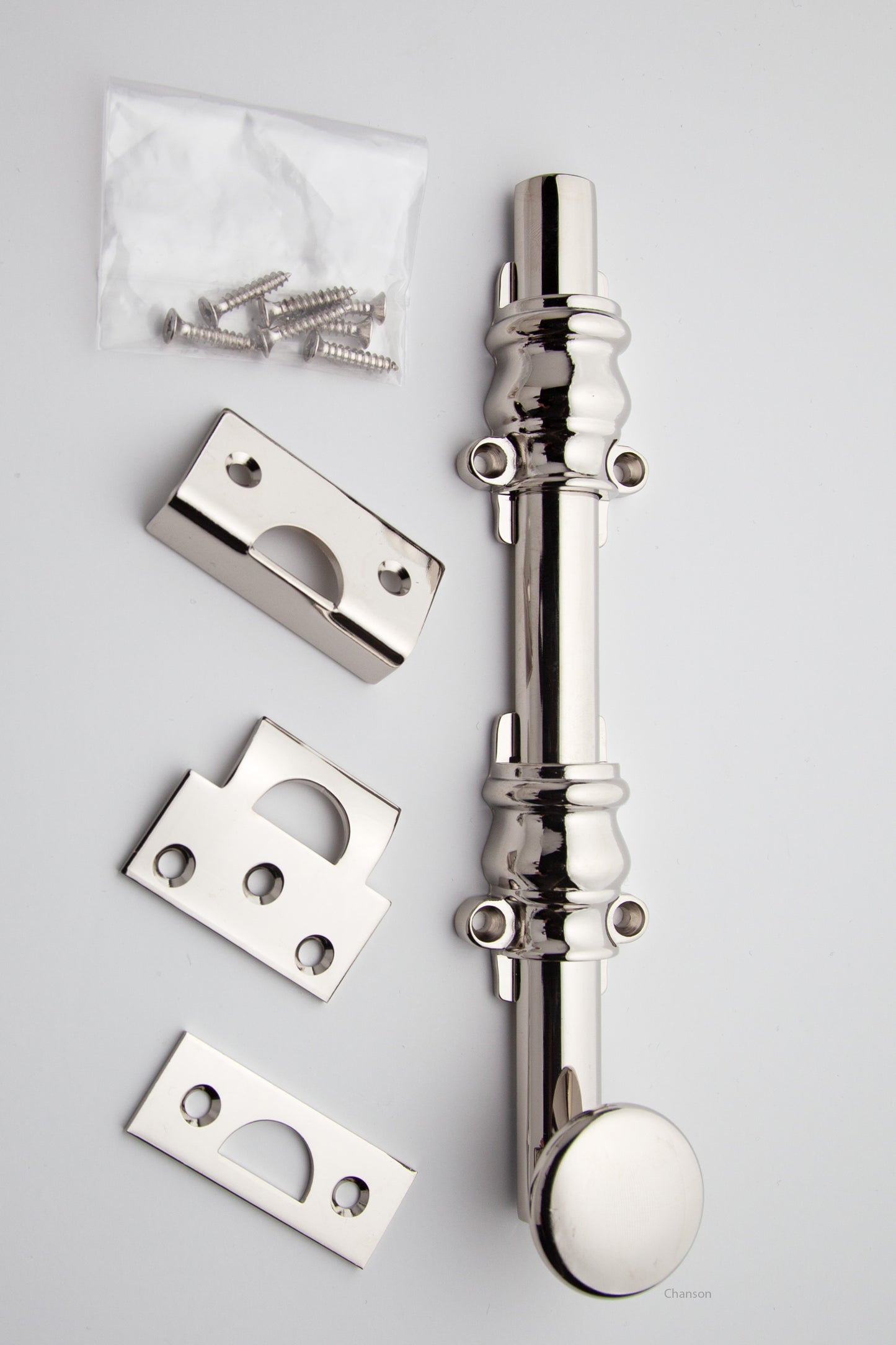 8 inch Solid Brass Surface Bolt with polished nickel finish US14 and Ornate, Ornamental, or Colonial style guides with finish matching screws along with angle, mortise, and surface strike.  All 3 strikes included.