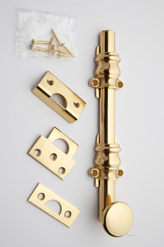 8 inch Solid Brass Surface Bolt with polished brass finish US3 and Ornate, Ornamental, or Colonial style guides with finish matching screws along with angle, mortise, and surface strike.  All 3 strikes included.