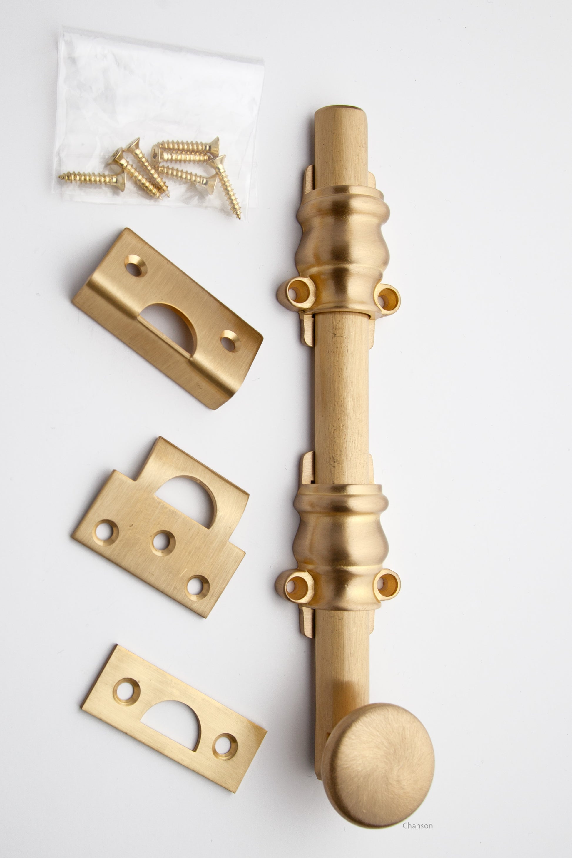 8 inch Solid Brass Surface Bolt with satin brass finish US4 and Ornate, Ornamental, or Colonial style guides with finish matching screws along with angle, mortise, and surface strike.  All 3 strikes included.