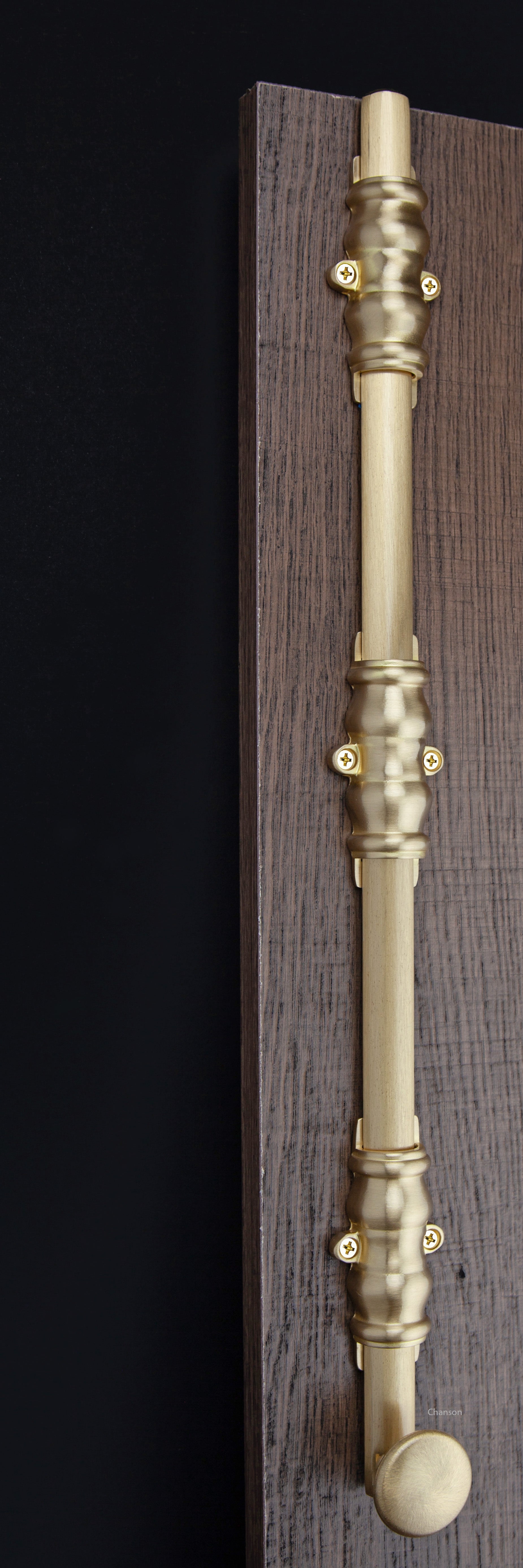 Lifestyle image for 18 inch solid brass surface bolt with ornate, ornamental, or colonial style guides.  Surface bolt is mounted on a door with finish matching screws.