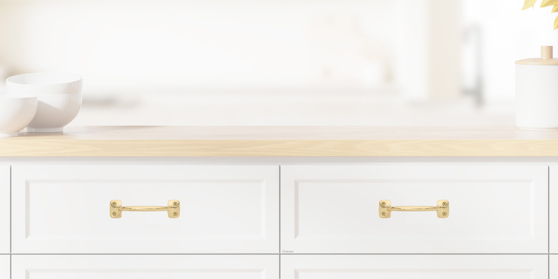 Chanson Hardware larger 4 inch center to center solid brass drawer pull shown on drawer front with polished brass finish
