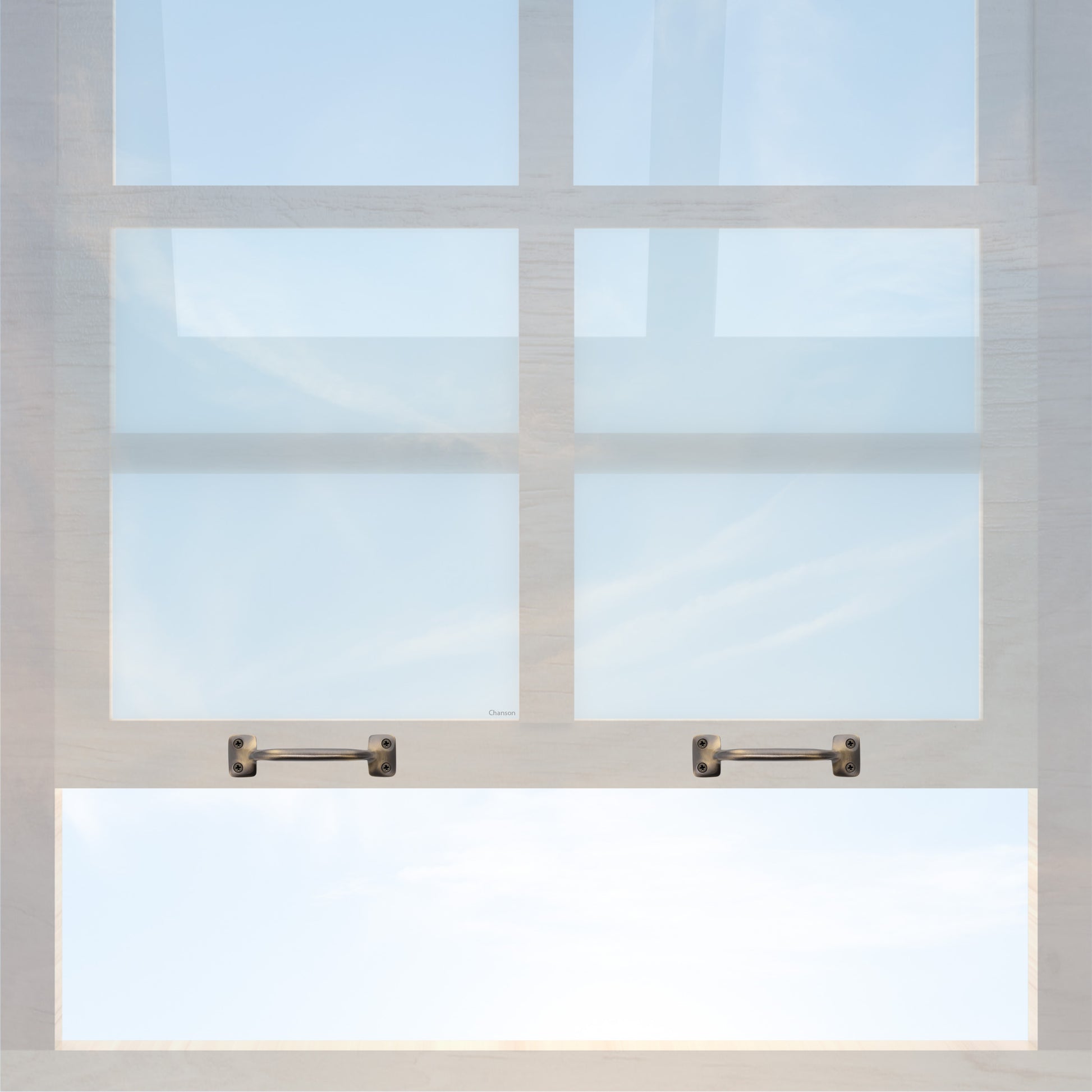 A wooden sash window with a pair of chanson hardware larger, 4 inch center to center solid brass bar type sash lifts in antique brass finish
