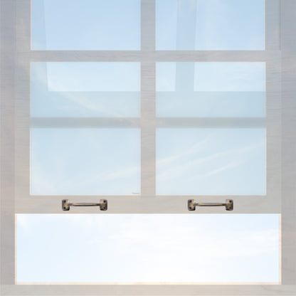A wooden sash window with a pair of chanson hardware larger, 4 inch center to center solid brass bar type sash lifts in antique brass finish