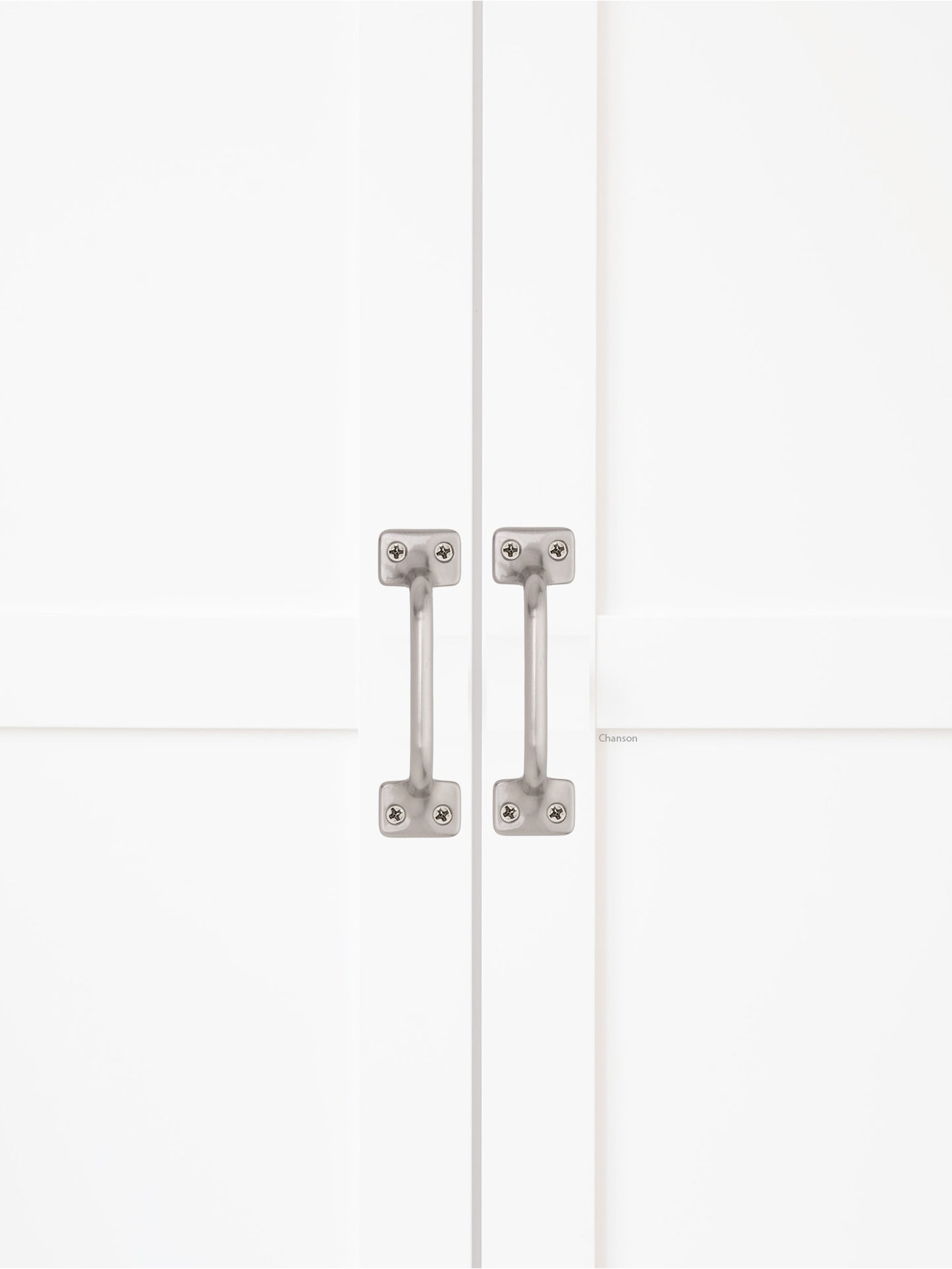 Chanson Hardware solid brass door pull shown on cabinet door in satin brass finish