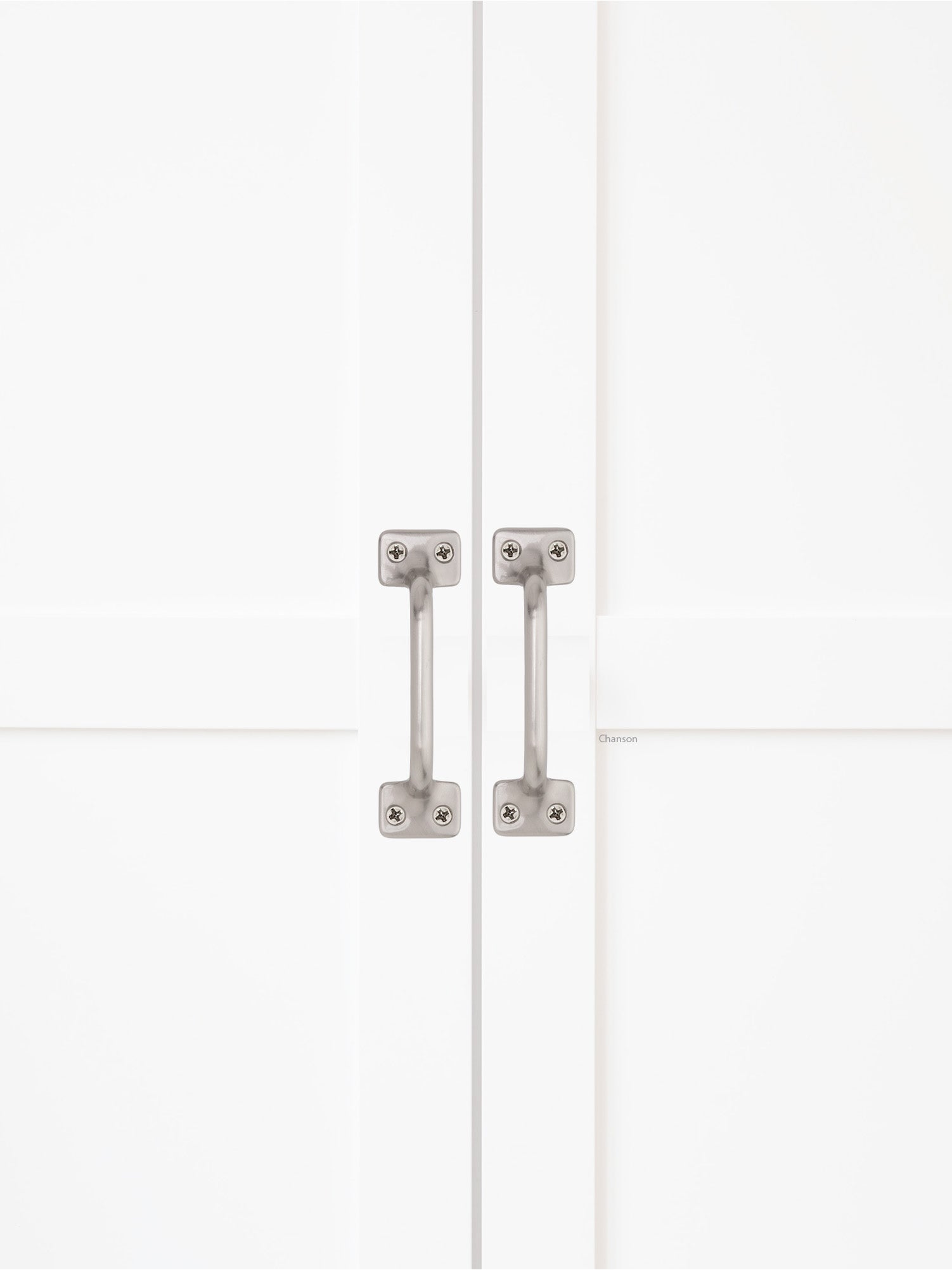 Chanson Hardware solid brass door pull shown on cabinet door in satin brass finish