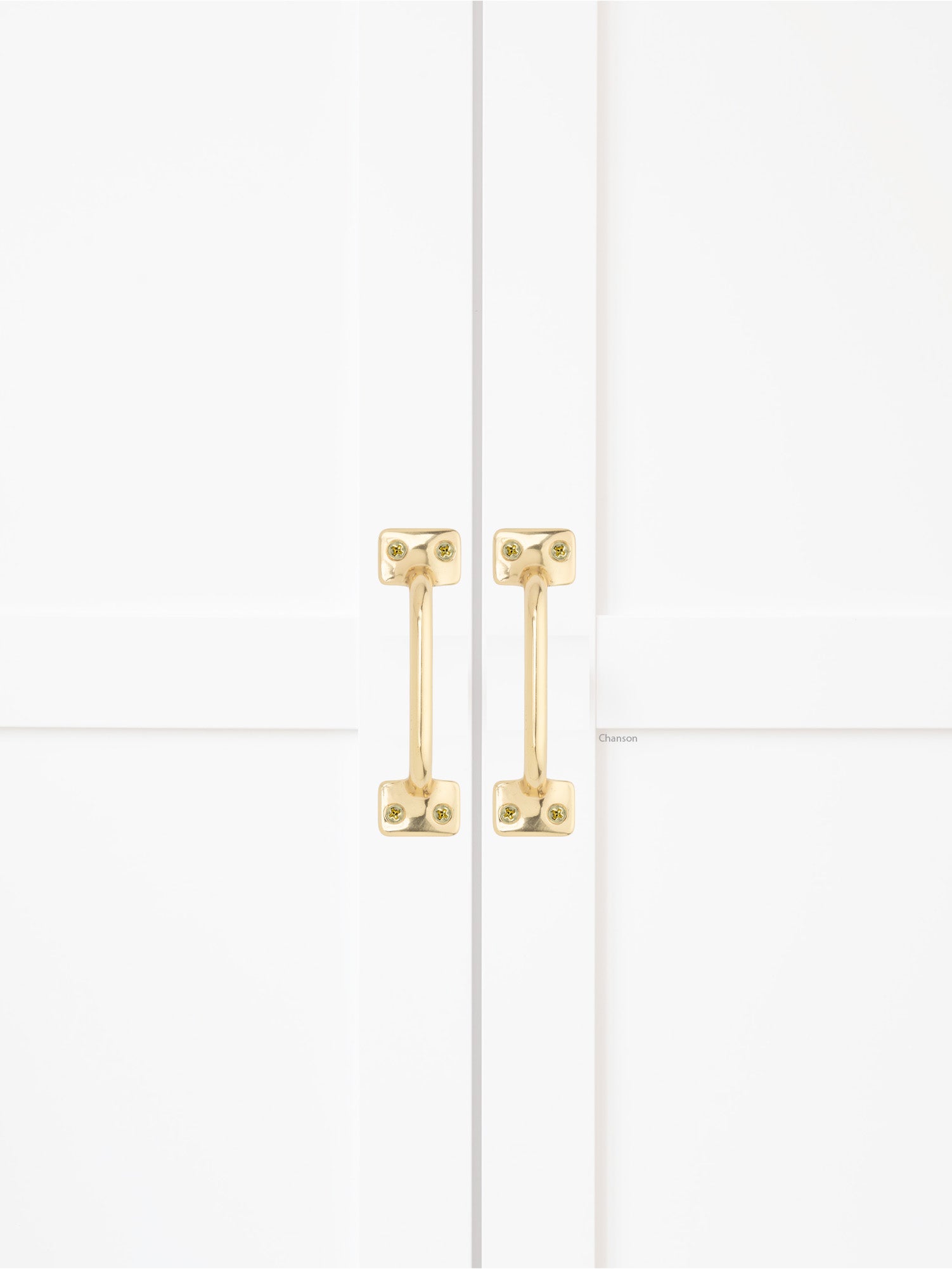 Chanson Hardware solid brass door pull shown on cabinet door in polished brass finish