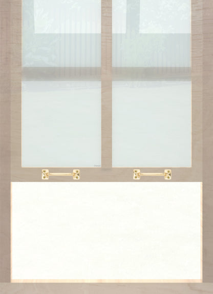 A wooden sash window with a pair of chanson hardware solid brass bar type sash lifts in polished brass finish
