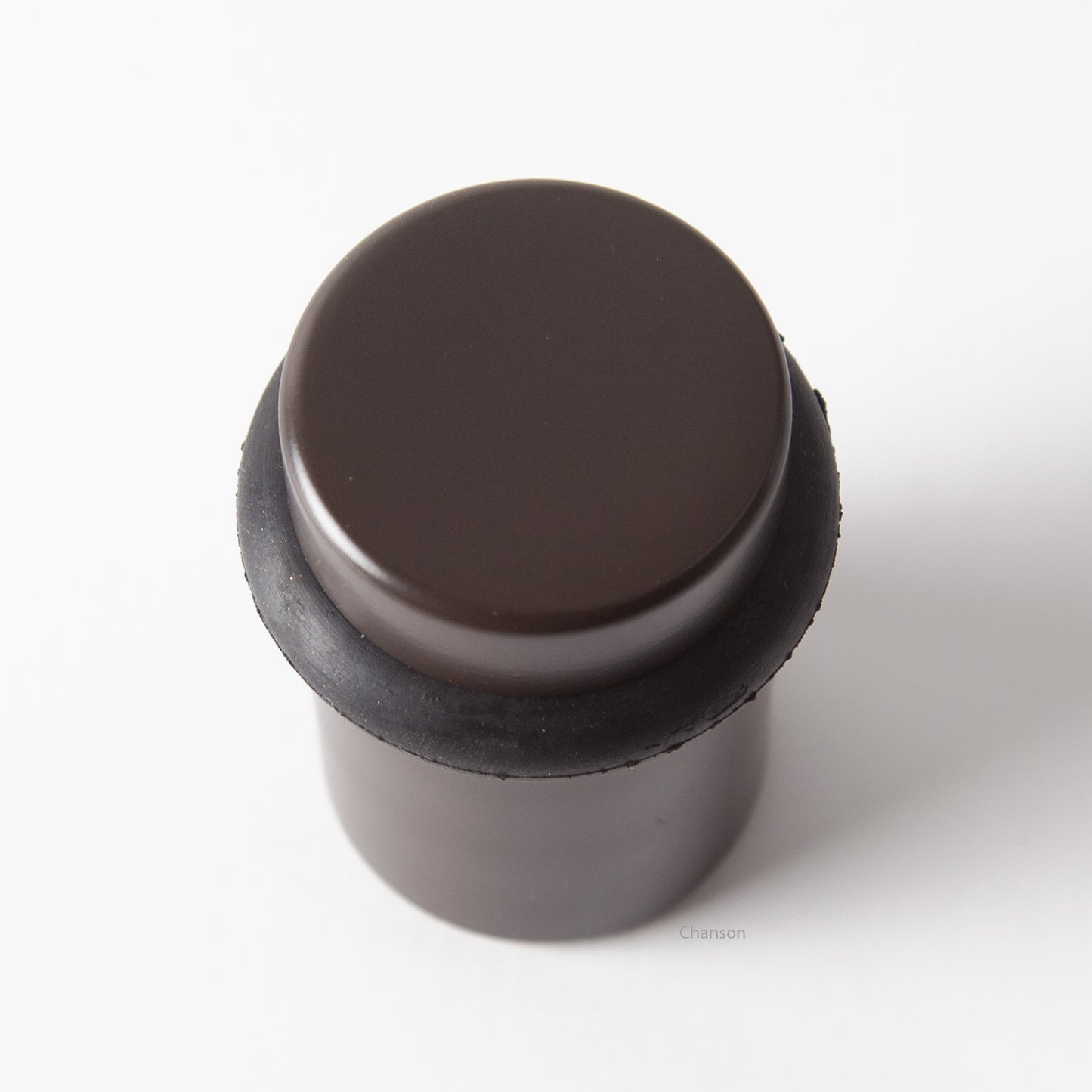 Top view of flat top solid brass cylindrical round floor doorstop in oil rubbed bronze finish US10B