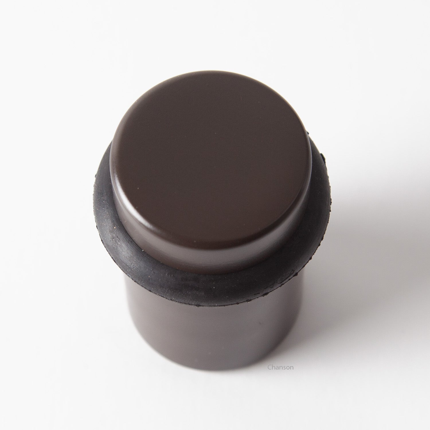 Top view of flat top solid brass cylindrical round floor doorstop in oil rubbed bronze finish US10B