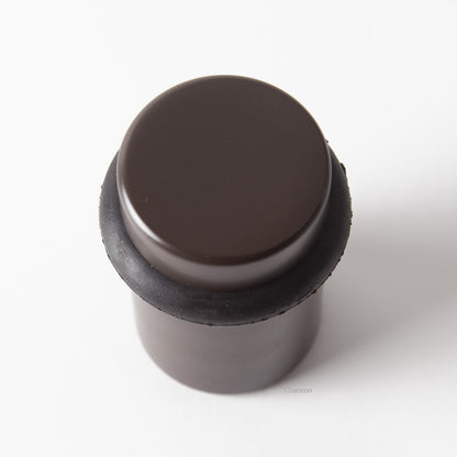 Top view of flat top solid brass cylindrical round floor doorstop in oil rubbed bronze finish US10B