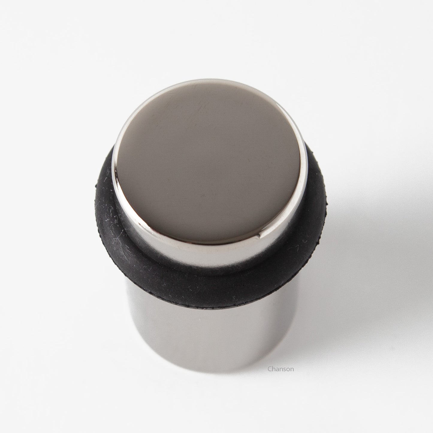 Top view of flat top solid brass cylindrical round floor doorstop in polished nickel finish US14