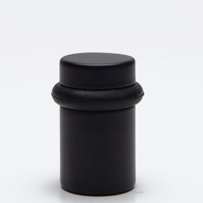 2 inch tall solid brass cylindrical shaped simple universal doorstop or floor bumper in flat or matte black finish US19