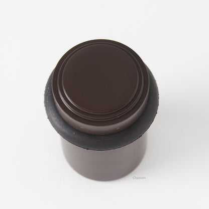 top view of chanson hardware tiered top solid brass doorstop that shows stepped design and cylindrical shape. Finish is oil rubbed bronze US10B.  Inspired by Art Deco