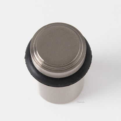 top view of chanson hardware tiered top solid brass doorstop that shows stepped design and cylindrical shape. Finish is satin or brushed nickel US15.  Inspired by Art Deco