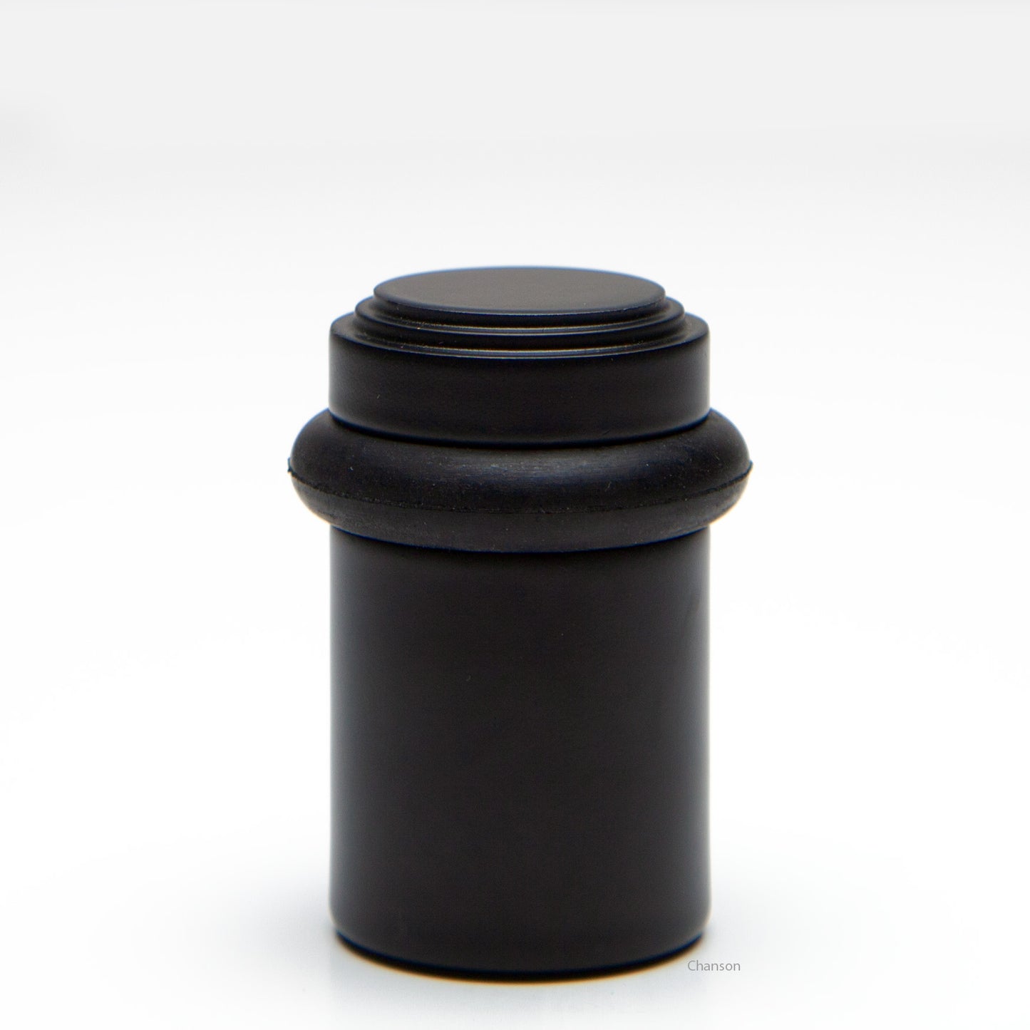2 inch solid brass decorative floor doorstop or bumper with stepped top and cylindrical top in flat or matte black US19 finish. Art Deco inspired