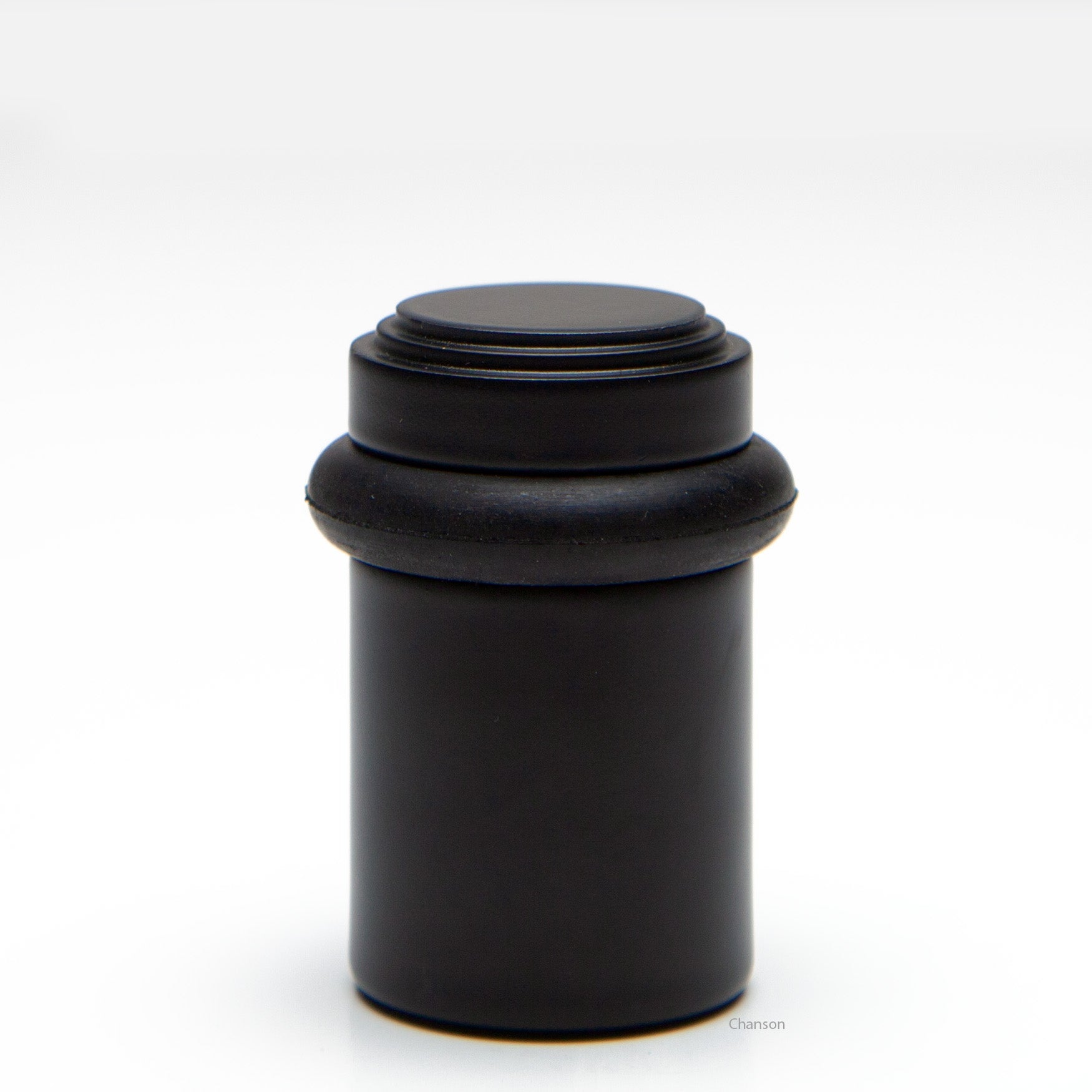 2 inch solid brass decorative floor doorstop or bumper with stepped top and cylindrical top in flat or matte black US19 finish. Art Deco inspired
