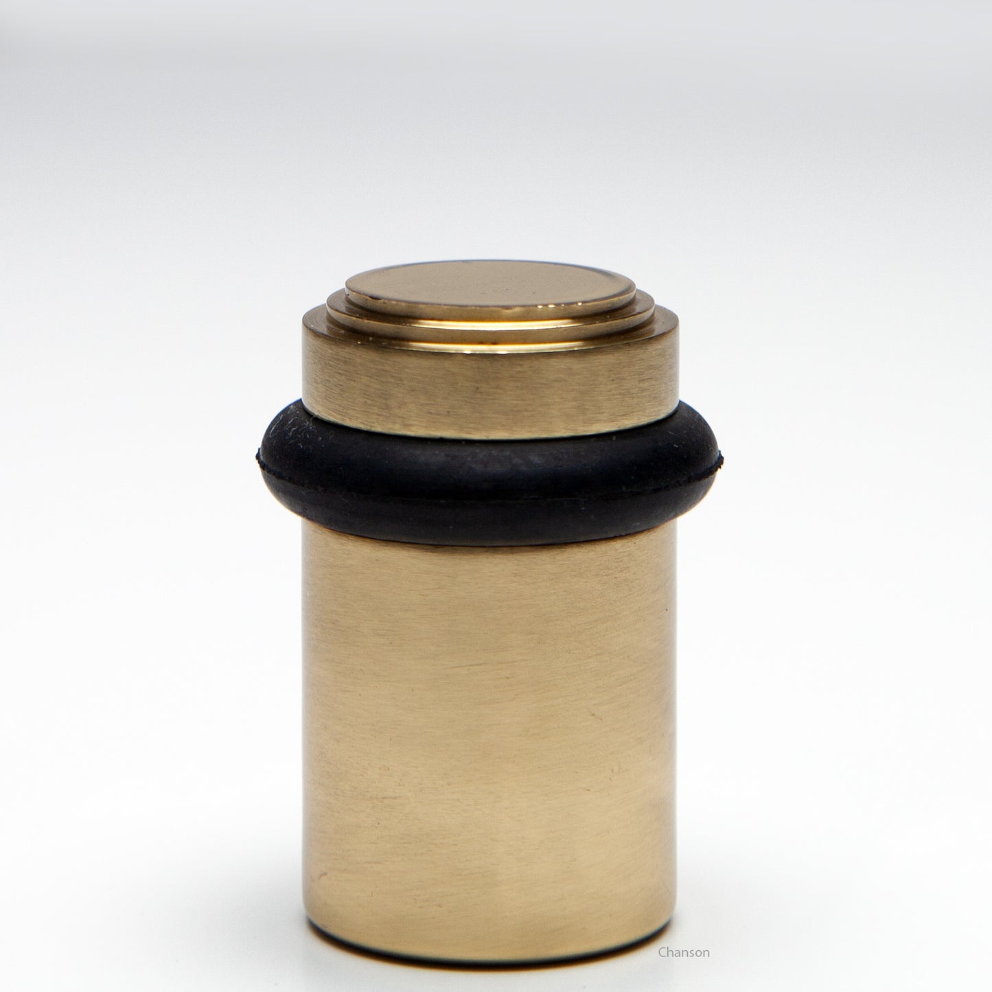 2 inch solid brass decorative floor doorstop or bumper with stepped top and cylindrical top in unlacquered  brass US3NL. Art Deco inspired