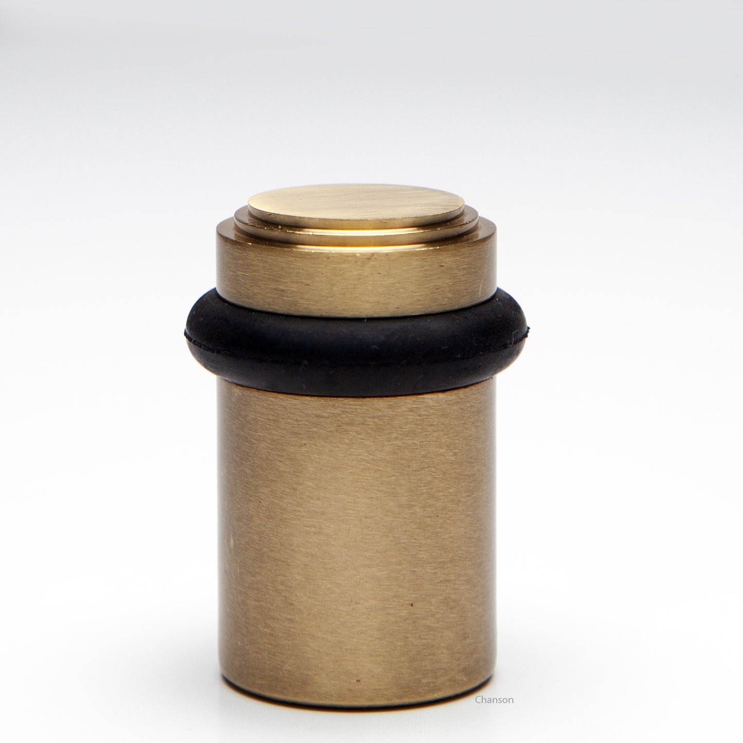 2 inch solid brass decorative floor doorstop or bumper with stepped top and cylindrical top in satin brass US4 finish. Art Deco inspired