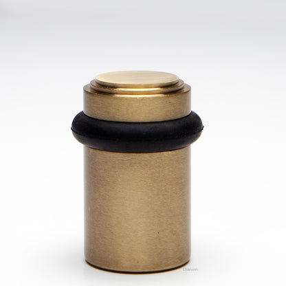 2 inch solid brass decorative floor doorstop or bumper with stepped top and cylindrical top in satin brass US4 finish. Art Deco inspired