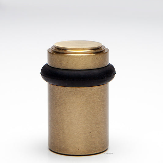 2 inch solid brass decorative floor doorstop or bumper with stepped top and cylindrical top in satin brass US4 finish. Art Deco inspired