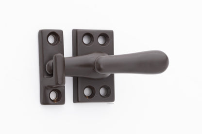Forged solid brass casement fastener latch unit engaged with surface strike in oil rubbed bronze finish US10B