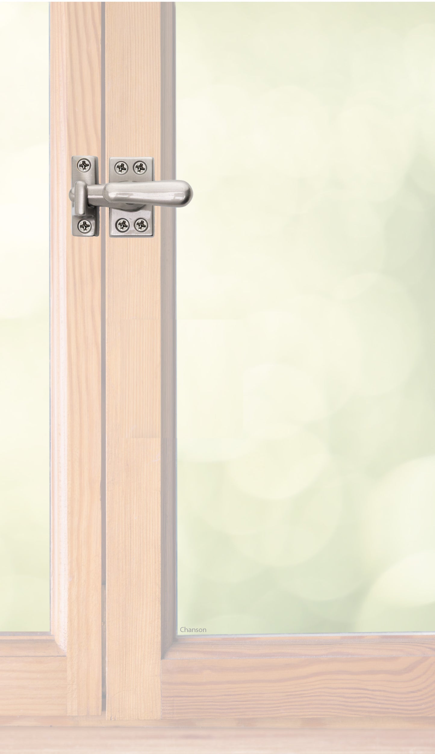 Traditional style solid brass casement fastener or window latch with a surface strike installed on a wooden swinging window, shown with satin nickel finish