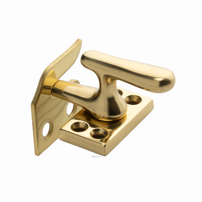 Solid brass casement fastener latch unit engaged with rim strike plate in polished brass US3 finish
