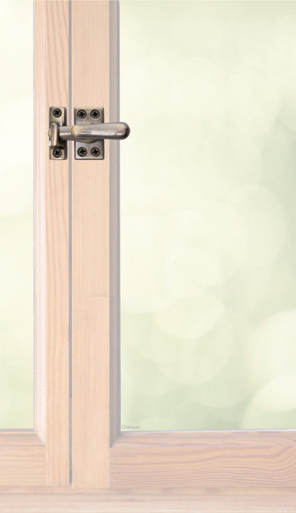 Traditional style solid brass casement fastener or window latch with a surface strike installed on a wooden swinging window, shown with antique brass finish