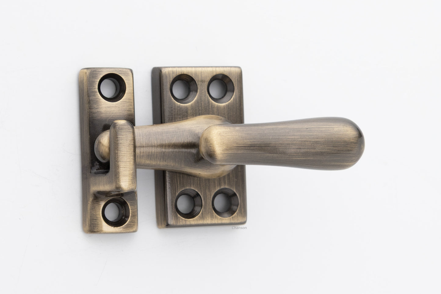 Forged solid brass casement fastener latch unit engaged with surface strike in antique brass US5 finish