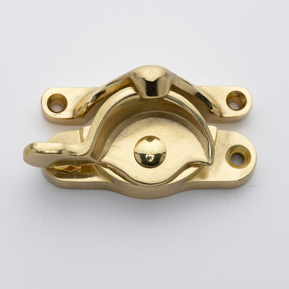 Classic or traditional large solid brass sash catch or sash window lock with hook style keeper and crescent shape in unlacquered brass US3NL finish