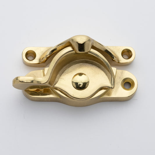 Classic or traditional large solid brass sash catch or sash window lock with hook style keeper and crescent shape in unlacquered brass US3NL finish