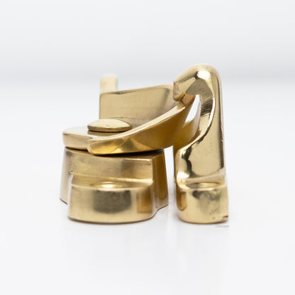 Side view of  large size solid brass sash catch, which shows latch engaging with hook strike or keeper. finish is unlacquered brass US3NL