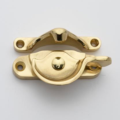 Classic style  large solid brass sash catch shown with lock turned open. Showcases hook shaped keeper and crescent shaped latch in unlacquered brass US3NL finish
