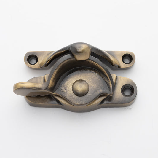 Classic or traditional large solid brass sash catch or sash window lock with hook style keeper and crescent shape in antique brass US5 finish