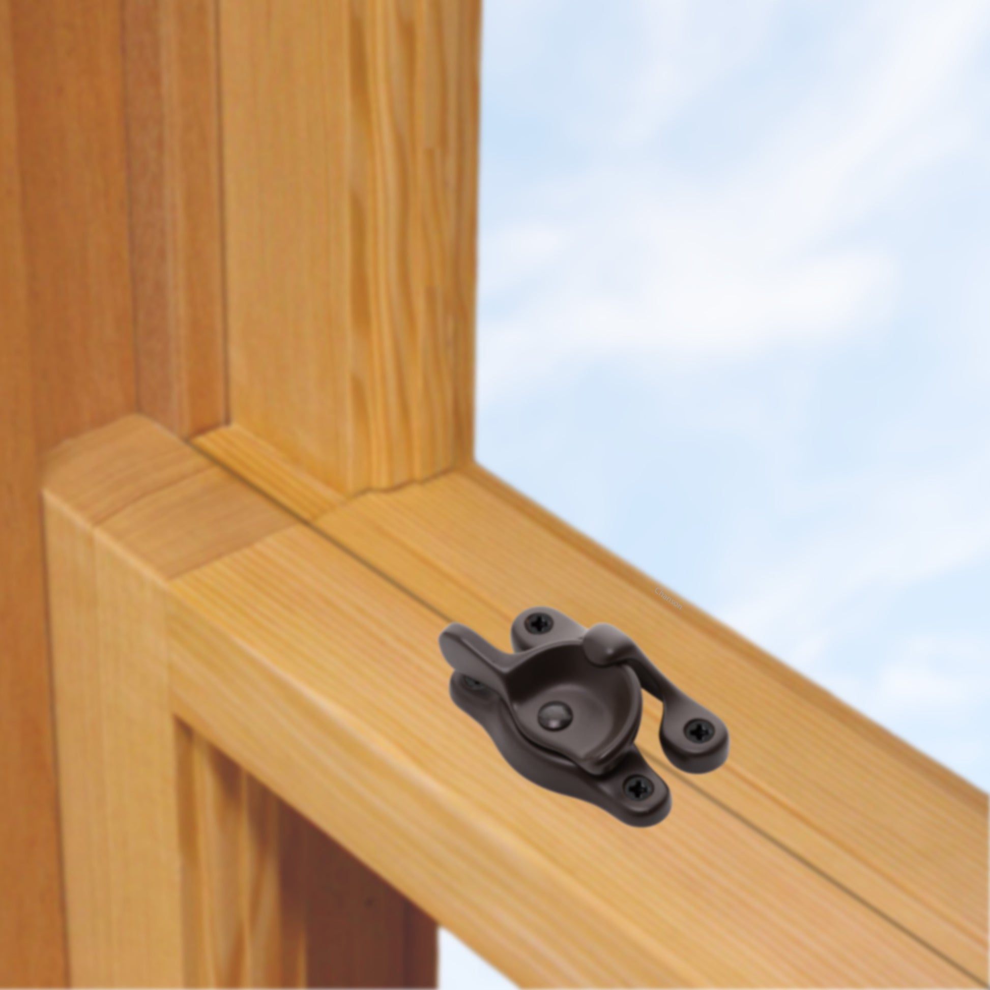 A wooden sash window, single or double hung, with a solid brass sash catch or latch installed on the meeting rail, shown in oil rubbed bronze finish