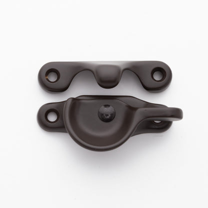 Classic style solid brass sash catch shown with lock turned open. Showcases hook shaped keeper and crescent shaped latch in oil rubbed bronze US10B finish