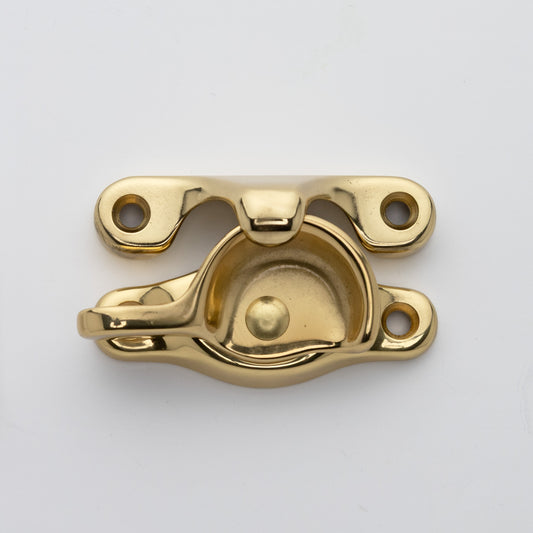 Classic or traditional solid brass sash catch or sash window lock with hook style keeper and crescent shape in polished brass US3 finish