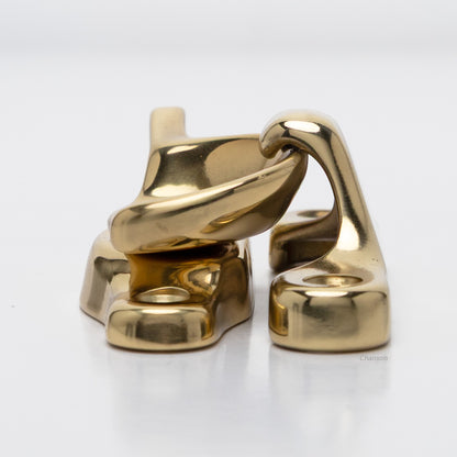 Side view of solid brass sash catch, which shows latch engaging with hook strike or keeper. finish is polished brass US3
