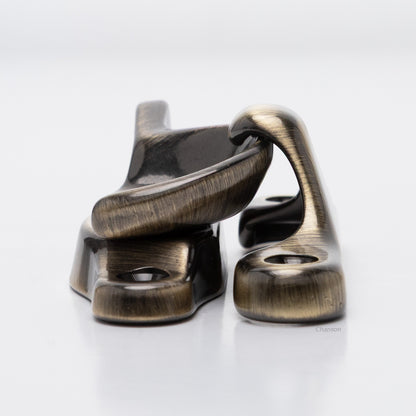 Side view of solid brass sash catch, which shows latch engaging with hook strike or keeper. finish is antique brass US5