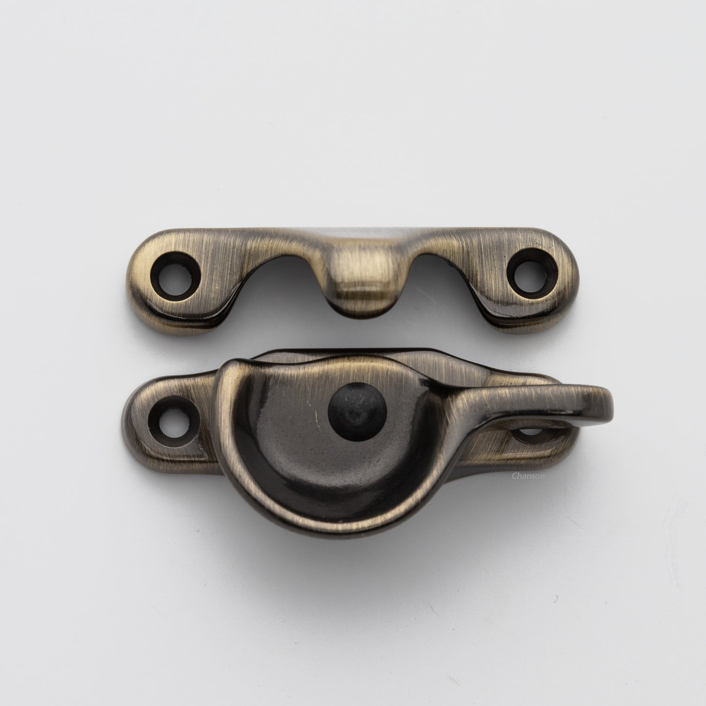Classic style solid brass sash catch shown with lock turned open. Showcases hook shaped keeper and crescent shaped latch in antique brass US5 finish