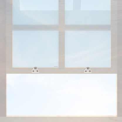 A wooden sash window with a pair of chanson hardware solid brass sash lifts that have a hook type design and a satin nickel finish