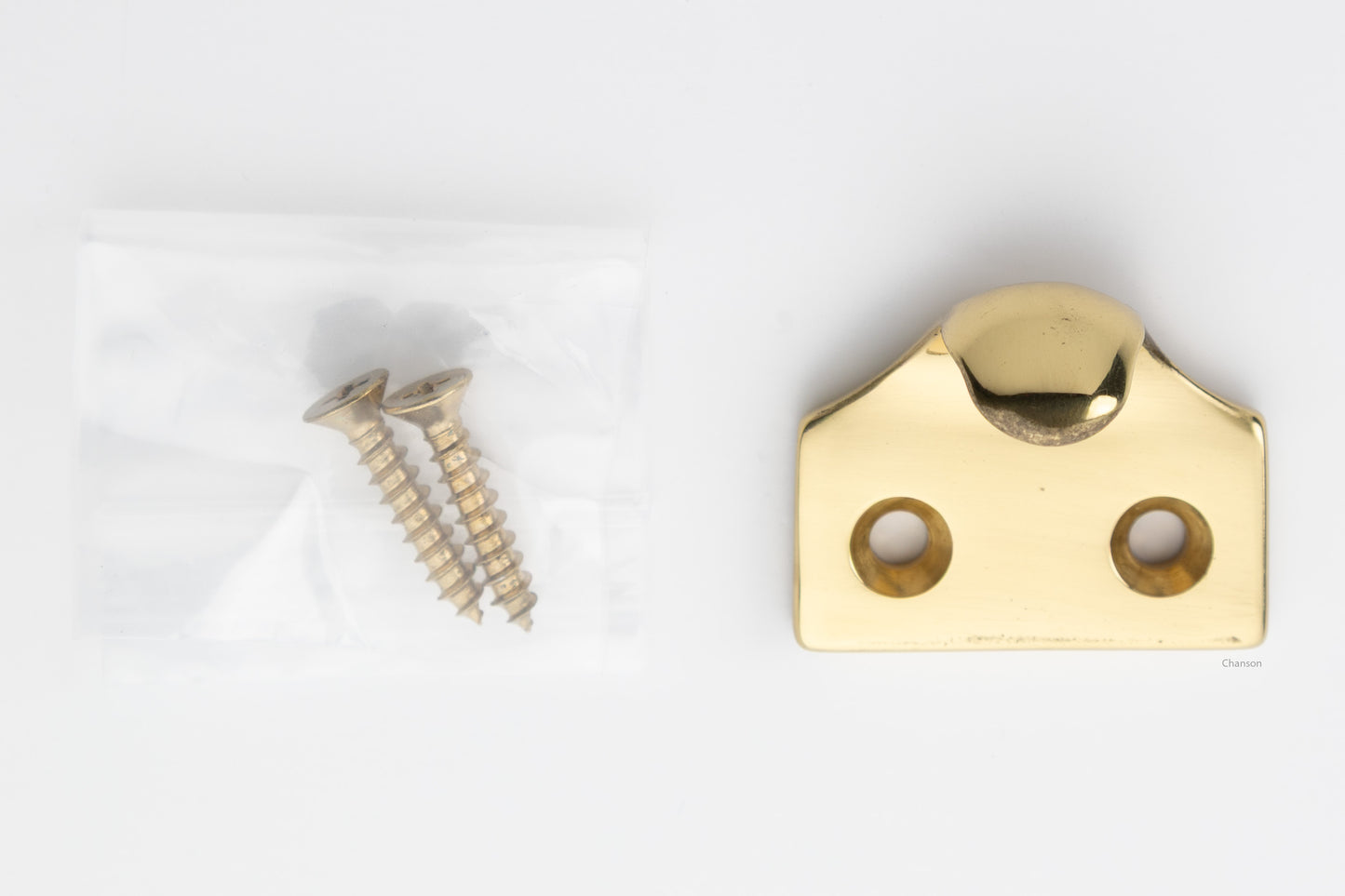 A classic traditional simple solid brass hook type sash window lift in unlacquered brass US3NL, along with finish matching screws