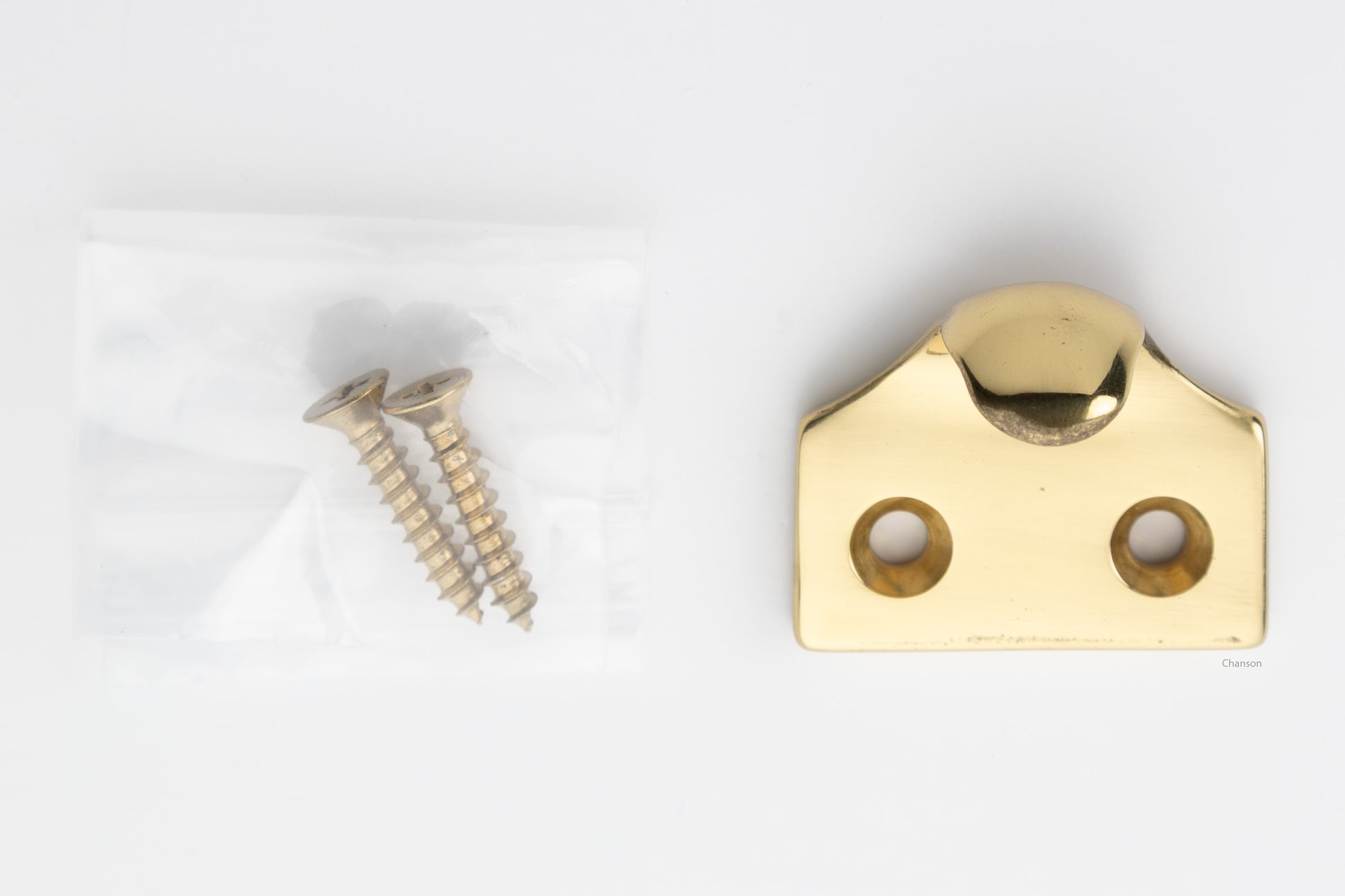 A classic traditional simple solid brass hook type sash window lift in polished brass US3, along with finish matching screws