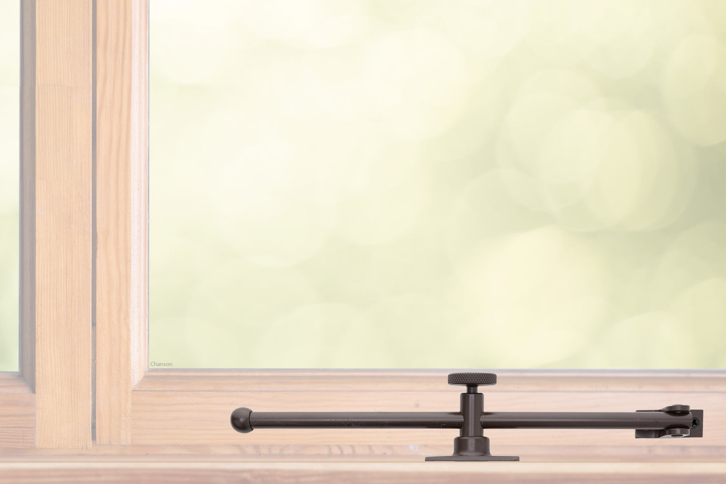 A sliding rod design solid brass casement adjustable stay with knob adjuster that is installed on the bottom sill or ledge of a outward swing window, shown in oil rubbed bronze finish