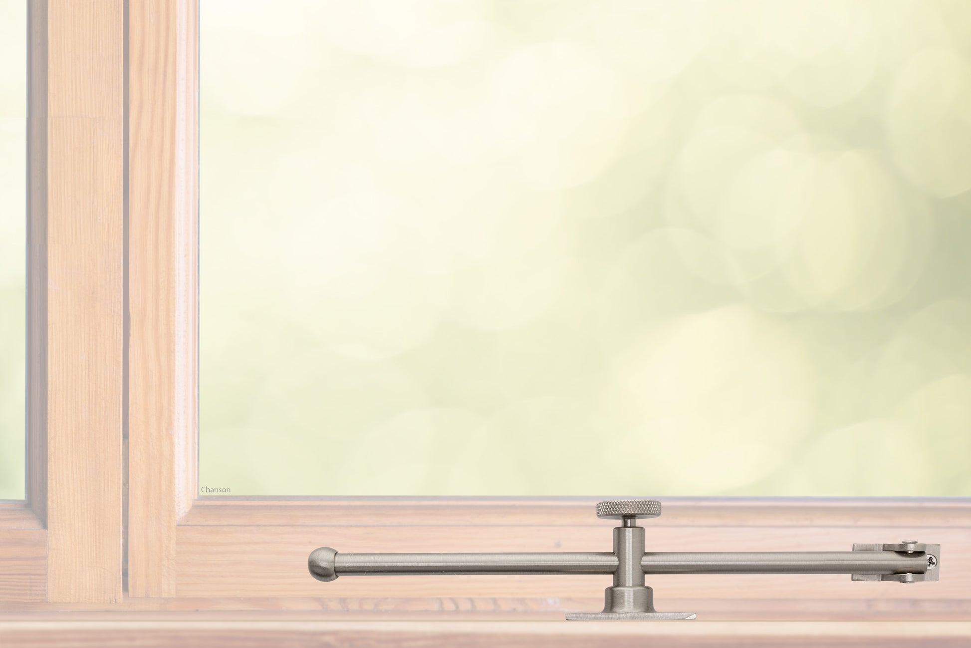 A sliding rod design solid brass casement adjustable stay with knob adjuster that is installed on the bottom sill or ledge of a outward swing window, shown in satin nickel finish