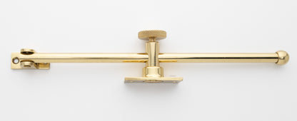 solid brass casement window adjuster or adjustable stay in polished brass finish US3 with sliding 10 inch rod and knurled knob