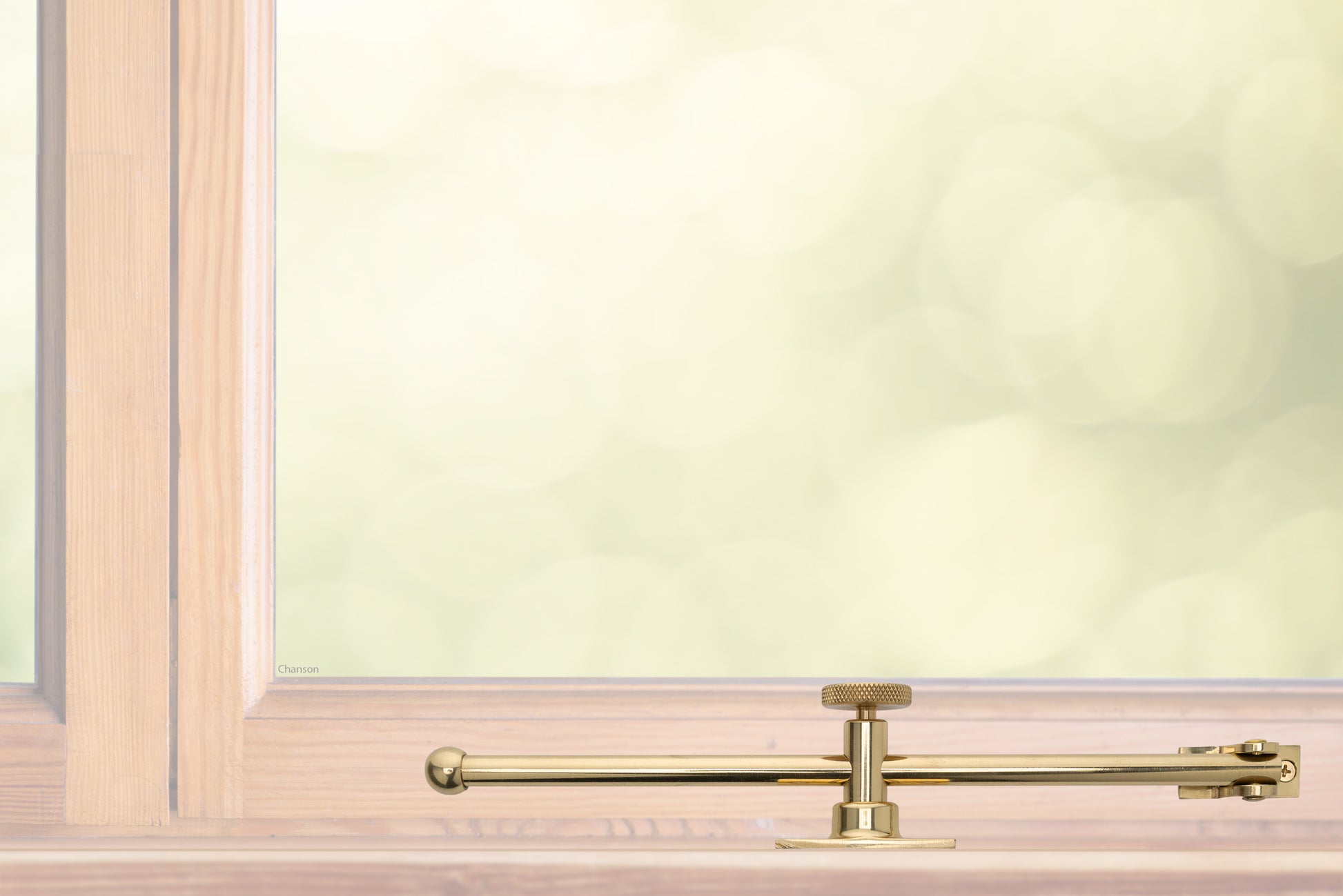 A sliding rod design solid brass casement adjustable stay with knob adjuster that is installed on the bottom sill or ledge of a outward swing window, shown in polished brass finish